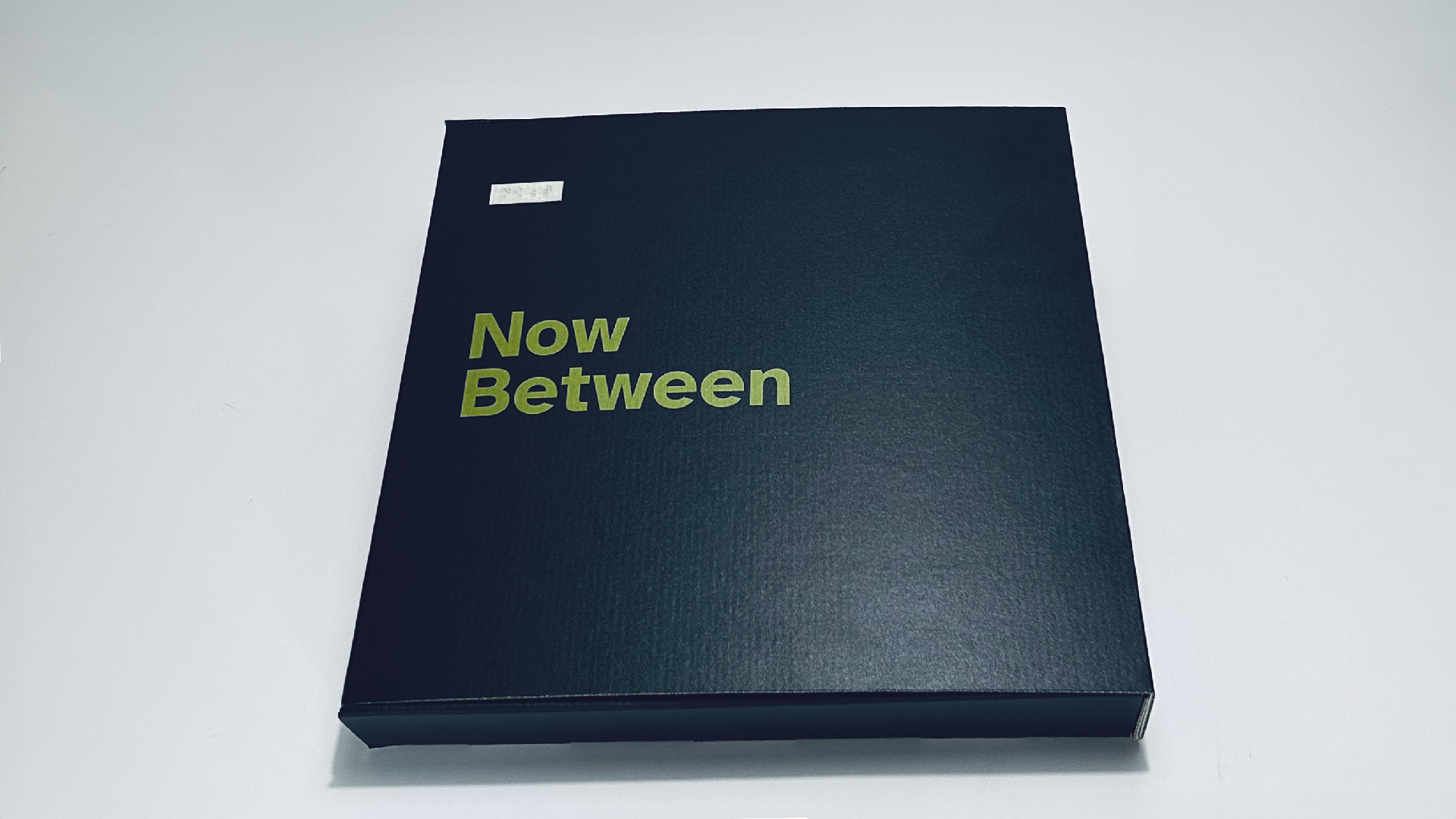 Figure 1. The front, spine, and back covers form an archival box that protects the artwork inside. The front of the box features a simple title set in the Atkinson Hyperlegible typeface. Above it is a block containing the title in Braille. © John O’Neill and Deanna Geneva Lorianni of Color to Sound, LLC