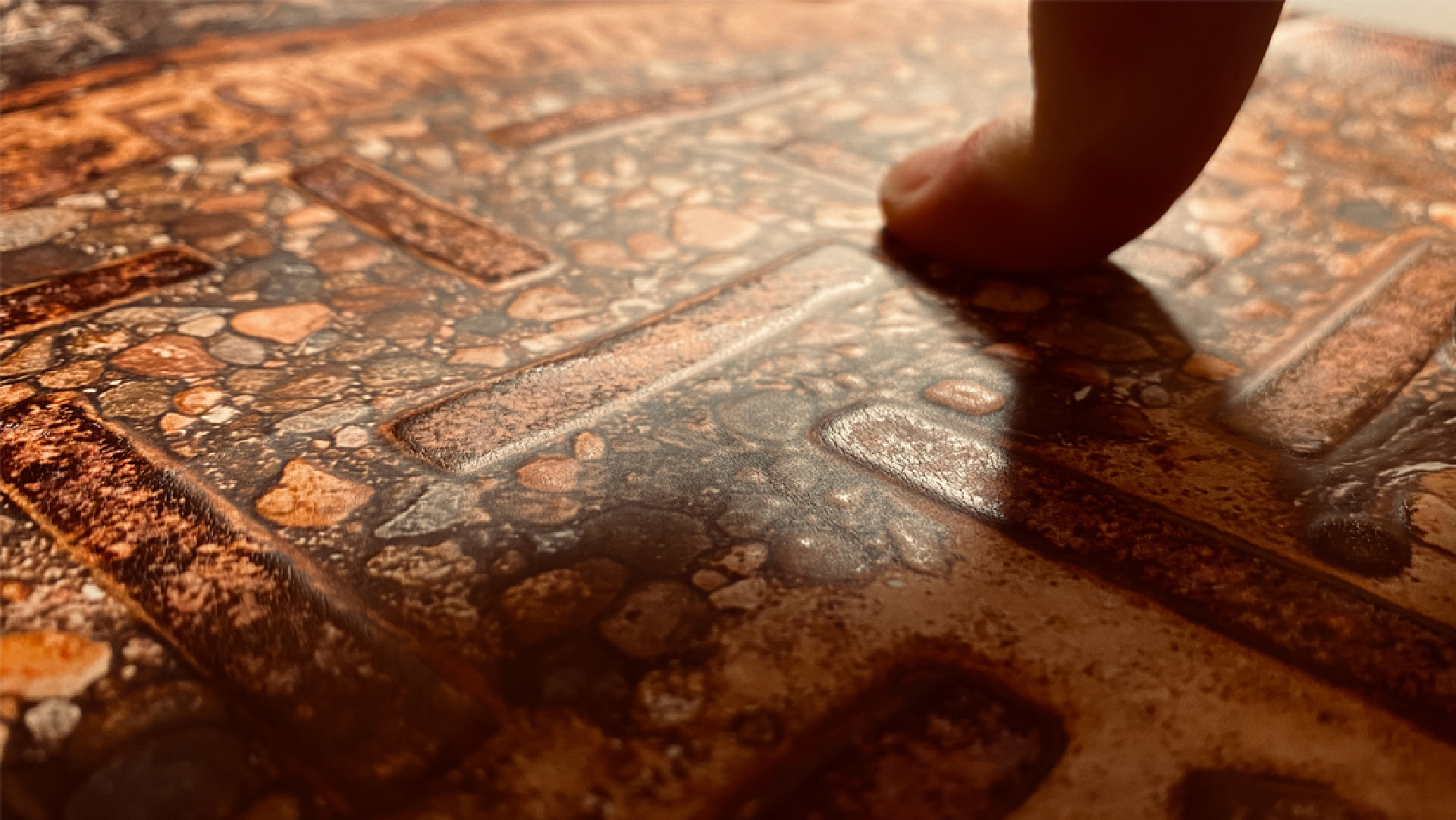 Figure 6. A test tactile print of the manhole cover, paired with the poem Here’s Our Foundry, was used to determine whether the varnish provided enough texture to distinguish the stones and traction ribs. © John O’Neill and Deanna Geneva Lorianni of Color to Sound, LLC