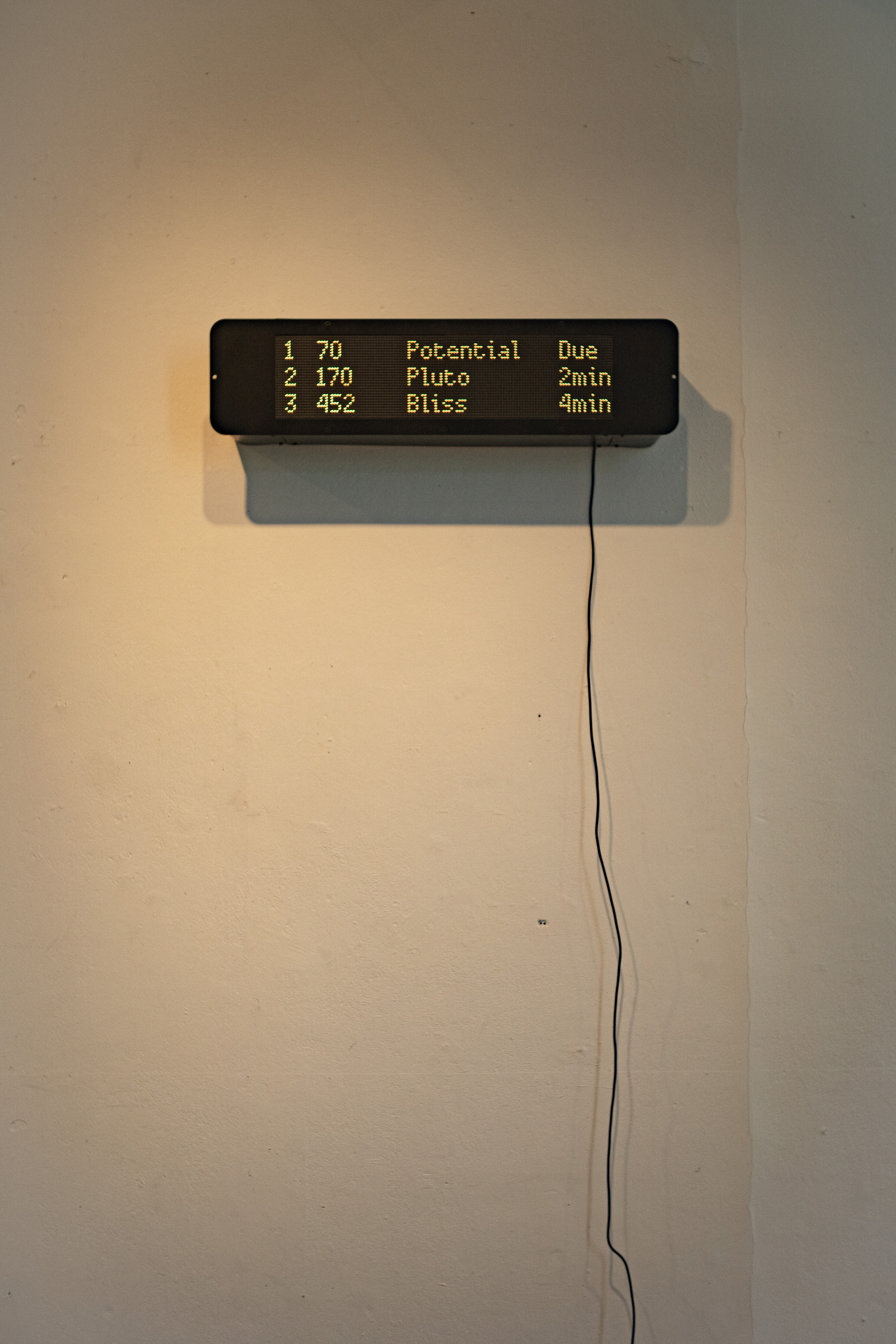 Figure 1 – The Promise of Happiness, 2025. Moving image sculpture. Timber, steel, aluminium, spray paint, single-board computer, and RGB matrices. Installation view, Upper Gulbenkian Gallery, Royal College of Art, London. Shown as part of “Outside of Formality: Street Furniture, Appropriation, Spatial Justice”, Street Study Group, 31st March–2nd April 2025. Image: © 2026 Max Livesey.