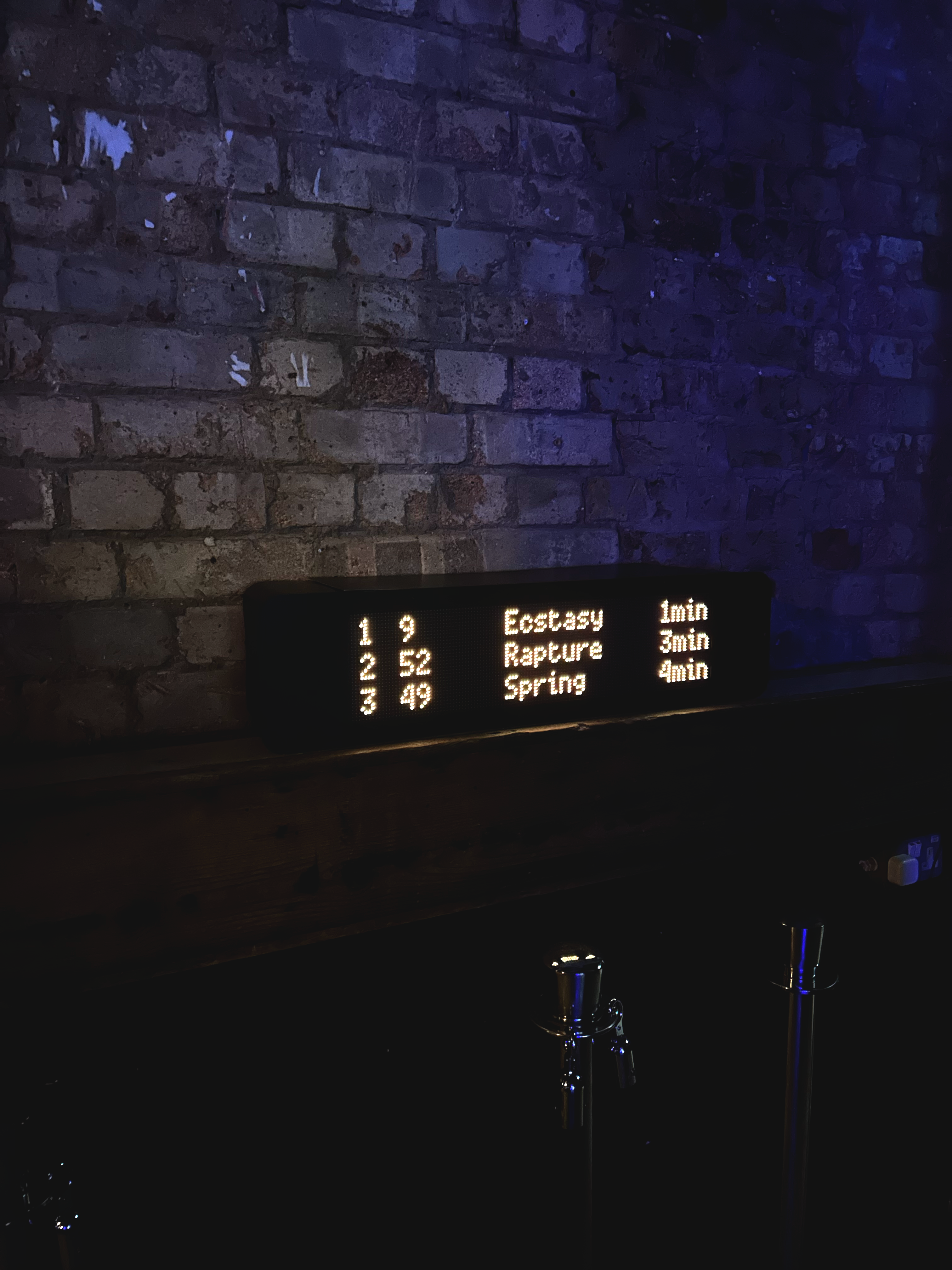Figure 3 – The Promise of Happiness, 2025. Moving image sculpture. Timber, steel, aluminium, spray paint, single-board computer, and RGB matrices. Installation view, Brixton Jamm, London. Shown as part of “Brutal Collective: Resurge”, 10th April 2026. Image: © 2026 Max Livesey.